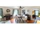 Cozy dining area with wood floors, round table, and decorated buffet cabinet for storage at 7810 Grevillea Dr, Orlando, FL 32822