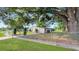 Cozy home featuring a fenced yard and beautiful mature tree at 7810 Grevillea Dr, Orlando, FL 32822