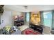 Cozy living room with a television, lamps, and patterned curtains for a comfortable atmosphere at 7810 Grevillea Dr, Orlando, FL 32822