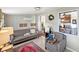 Comfortable living room featuring a gray sofa, an armchair, and neutral décor at 7810 Grevillea Dr, Orlando, FL 32822
