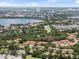 An aerial shot showcasing the neighborhood, nearby lake, and city skyline in the distance at 7856 Sugar Bend Dr # 7856, Orlando, FL 32819