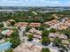 Expansive aerial view of a residential neighborhood with a community pool and tennis courts at 7856 Sugar Bend Dr # 7856, Orlando, FL 32819