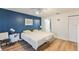Bedroom with a calm blue accent wall, two beds and bright, natural light at 7856 Sugar Bend Dr # 7856, Orlando, FL 32819