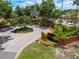 Landscaped community entrance with signage and lush greenery at 7856 Sugar Bend Dr # 7856, Orlando, FL 32819