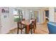 Warm dining room featuring wood floors and a view of the outdoors through sliding glass doors at 7856 Sugar Bend Dr # 7856, Orlando, FL 32819