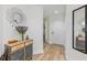 Stylish entryway featuring wood flooring, a decorative mirror, and a wooden console table at 7856 Sugar Bend Dr # 7856, Orlando, FL 32819