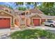 Charming multi-Gathering home featuring well-kept lawns and vibrant red garage doors at 7856 Sugar Bend Dr # 7856, Orlando, FL 32819