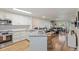 Open-concept kitchen flows into living area with modern appliances and sleek countertops at 7856 Sugar Bend Dr # 7856, Orlando, FL 32819
