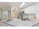 Bright kitchen with white cabinets, stainless steel appliances, and a spacious quartz countertop at 7856 Sugar Bend Dr # 7856, Orlando, FL 32819