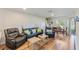 Cozy living room with leather furniture, wood floors, and natural light at 7856 Sugar Bend Dr # 7856, Orlando, FL 32819