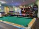 Spacious game room featuring a pool table, ping pong tables, and arcade games for endless entertainment at 8023 King Palm Cir, Kissimmee, FL 34747