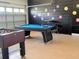 Fun game room with pool table, foosball, and whimsical wall decor for entertainment at 8023 King Palm Cir, Kissimmee, FL 34747