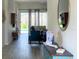 Hallway view of living room showing sliding glass doors to pool with hardwood-style floors at 8023 King Palm Cir, Kissimmee, FL 34747