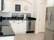 Spacious kitchen featuring modern appliances, white cabinetry, and black granite countertops at 8023 King Palm Cir, Kissimmee, FL 34747