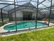 A beautiful screened-in pool with clear water, nestled in a lush green yard at 8023 King Palm Cir, Kissimmee, FL 34747