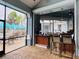 Poolside bar with a tropical design, featuring overhead lighting, bar stools, and views of the pool and palm trees at 8023 King Palm Cir, Kissimmee, FL 34747