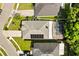 Aerial view of the home highlighting the pool with screened enclosure and solar panels on the roof at 8852 Fort Jefferson Blvd, Orlando, FL 32822