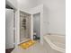 Bathroom features bathtub, shower, and neutral-colored tile at 8852 Fort Jefferson Blvd, Orlando, FL 32822