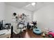 Bedroom showcasing wood floors, a ceiling fan, and shelving with lots of items at 8852 Fort Jefferson Blvd, Orlando, FL 32822