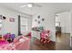 Colorful bedroom featuring a cute pink toddler bed and wood flooring at 8852 Fort Jefferson Blvd, Orlando, FL 32822