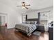 Bedroom features wood flooring, ceiling fan, and large bed at 8852 Fort Jefferson Blvd, Orlando, FL 32822