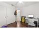 Bedroom featuring wood floors, white walls, closet, and door to the bathroom at 8852 Fort Jefferson Blvd, Orlando, FL 32822