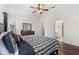 Bedroom with dark wood floor, ceiling fan, and adjacent bath at 8852 Fort Jefferson Blvd, Orlando, FL 32822