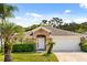 Charming single-story home with a well-manicured lawn and a two-car garage on a sunny day at 8852 Fort Jefferson Blvd, Orlando, FL 32822