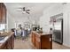 Modern kitchen with stainless steel appliances, dark cabinets, island, and open layout at 8852 Fort Jefferson Blvd, Orlando, FL 32822