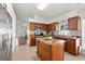 Updated kitchen with dark wood cabinets, stainless appliances, and a center island at 8852 Fort Jefferson Blvd, Orlando, FL 32822