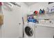 Bright laundry room featuring washer, dryer and shelving for organized storage at 8852 Fort Jefferson Blvd, Orlando, FL 32822