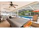 View of the pool area with covered patio, pool table, lounge chairs, and fenced-in backyard at 8852 Fort Jefferson Blvd, Orlando, FL 32822