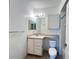 Small bathroom with sink, countertop, a mirror, a toilet and cabinet at 8929 Legacy Ct # 208, Kissimmee, FL 34747