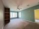 Bedroom with neutral carpet, ceiling fan, a window and built-in shelving at 8929 Legacy Ct # 208, Kissimmee, FL 34747