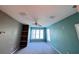 Bedroom with neutral carpet, ceiling fan, and large window at 8929 Legacy Ct # 208, Kissimmee, FL 34747