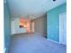 Living room with neutral carpet, ceiling fan, and view into the kitchen at 8929 Legacy Ct # 208, Kissimmee, FL 34747