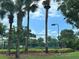 Community tennis courts enclosed with fencing and featuring mature trees for shade at 8929 Legacy Ct # 208, Kissimmee, FL 34747