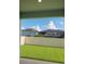 View of a home's backyard featuring artificial turf, a fence and an enclosed pool at 1168 Citrus Landings Blvd, Davenport, FL 33837