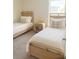 Shared bedroom featuring two twin beds with wooden frames, bedside table, carpet and natural light at 1168 Citrus Landings Blvd, Davenport, FL 33837