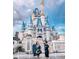 Couple at Cinderella's Castle for an unforgettable magical experience at 1168 Citrus Landings Blvd, Davenport, FL 33837