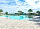 Community pool with lounge chairs, tables, and shade for a relaxing outdoor experience at 1168 Citrus Landings Blvd, Davenport, FL 33837