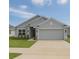 Charming single Gathering home featuring a two car garage, well maintained lawn, and welcoming front entrance at 1168 Citrus Landings Blvd, Davenport, FL 33837