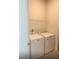 Laundry room featuring a washer, dryer and a wire shelf above at 1168 Citrus Landings Blvd, Davenport, FL 33837