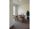 Office with carpet, a modern desk, chair, and an indoor potted tree by the window at 1168 Citrus Landings Blvd, Davenport, FL 33837