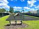 Community playground with slide, swings, and a soft surface surrounded by lush green lawns at 1168 Citrus Landings Blvd, Davenport, FL 33837