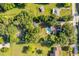 Overhead view of a home with a pool, outbuildings, and a spacious, tree-lined lot at 1206 Culver Rd, Orlando, FL 32825