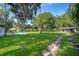 Expansive backyard featuring lush greenery, a pool, and additional outbuilding, perfect for outdoor activities and storage at 1206 Culver Rd, Orlando, FL 32825