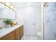 Bathroom featuring double vanity, marble countertops, and shower with a marble-style surround at 1206 Culver Rd, Orlando, FL 32825