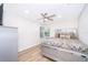Bright bedroom featuring a large window, ceiling fan and a stylish, mirrored bed frame at 1206 Culver Rd, Orlando, FL 32825