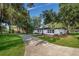 Beautifully renovated home with a long driveway, surrounded by mature trees and professional landscaping at 1206 Culver Rd, Orlando, FL 32825